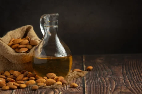 almond-oil-bottle-dark-wood-background