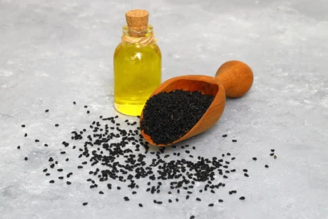 black-cumin-seeds-essential-oil-with-bowl-wooden-shovel-spoon-nigella-sativa