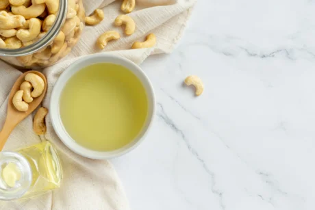 cashew-nuts-oil-with-cashew-nuts-marble-background