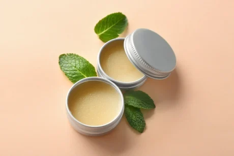 containers-with-lemon-balm-salve-leaves-light-background